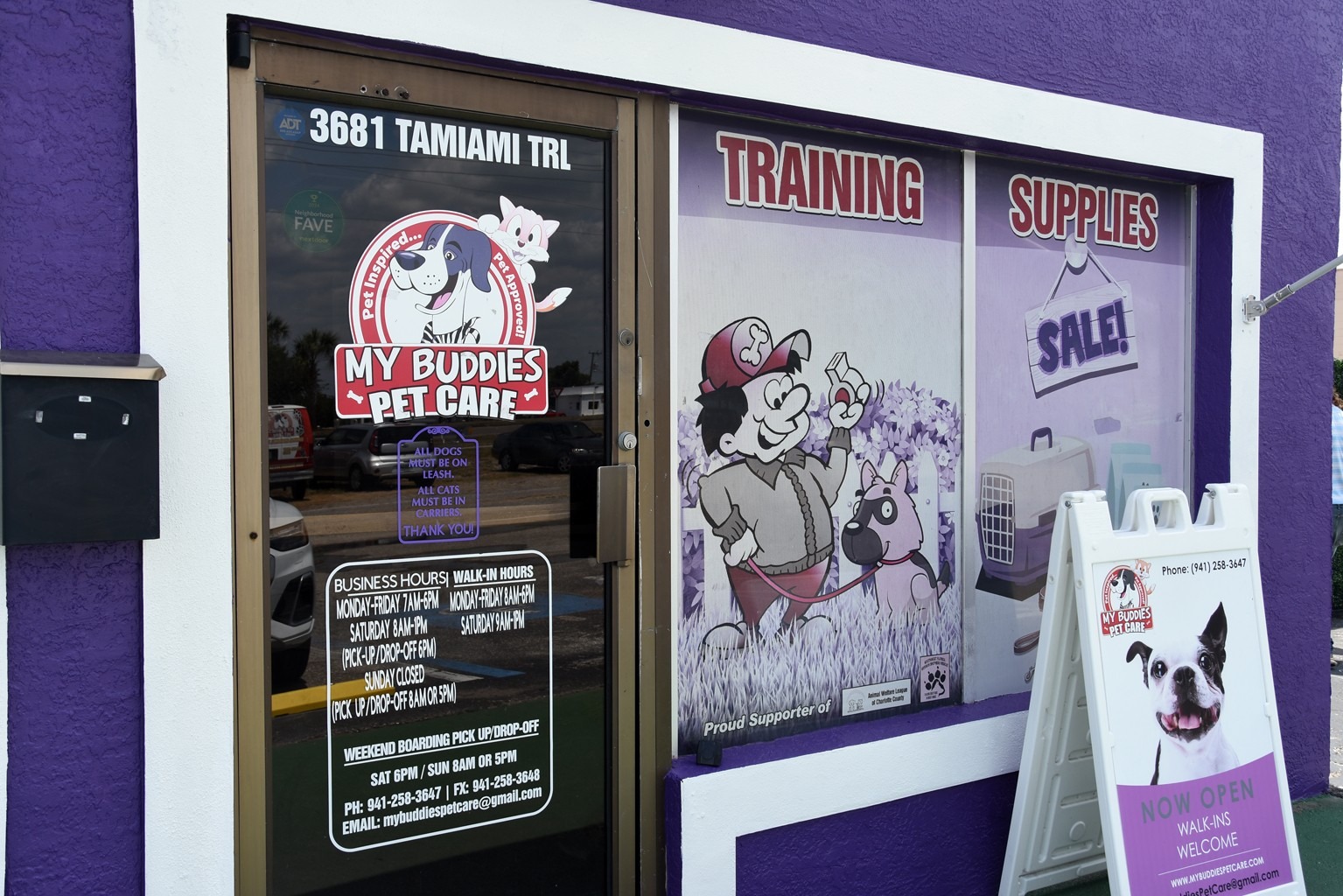 "Exterior of My Buddies Pet Care, showcasing pet training and supplies. The sign indicates services, hours, and a welcoming message for walk-ins."
